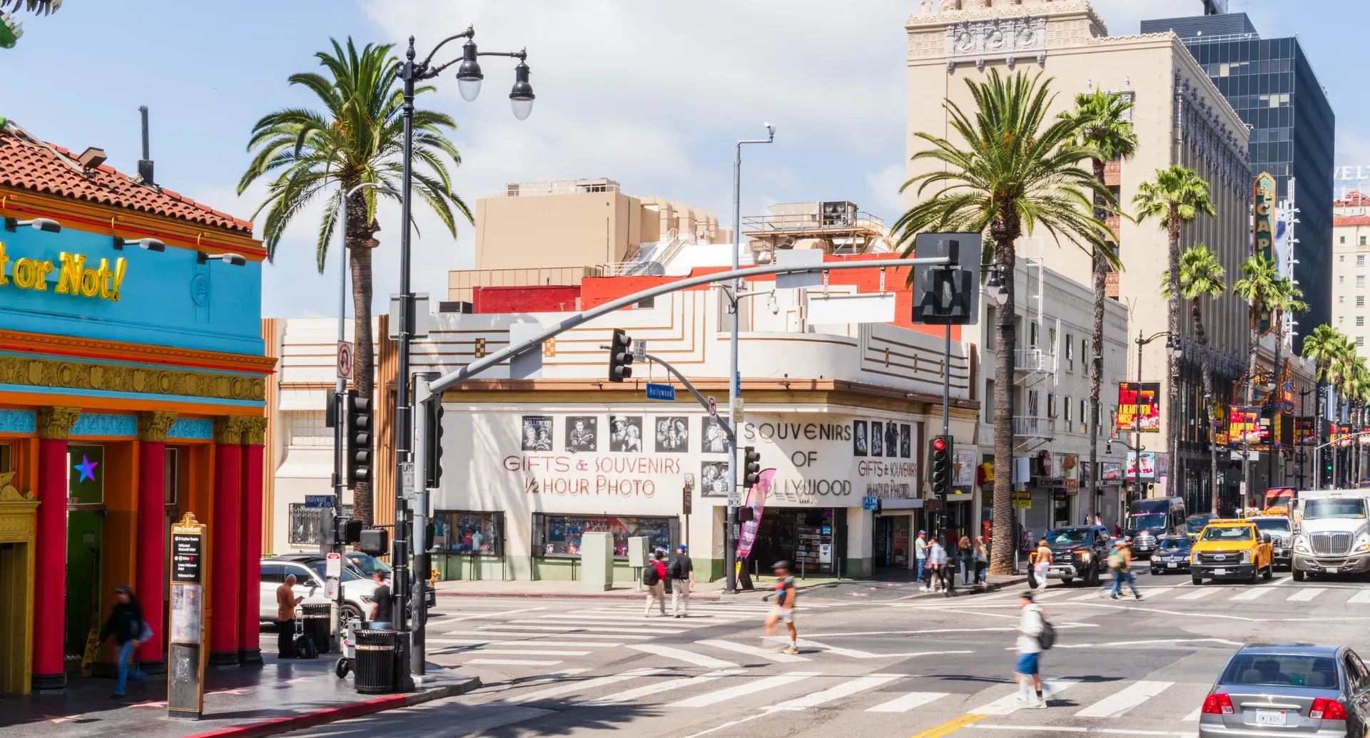 Busy street scene on Hollywood Boulevard with souvenir shops under palm trees, Los Angeles. in Hollywood Scavenger Hunt