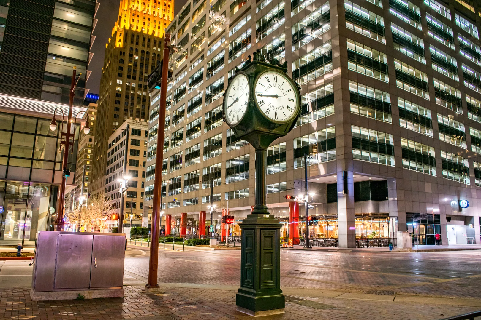 Illuminated clock and modern skyscrapers in downtown Houston at night. in Houston Scavenger Hunt