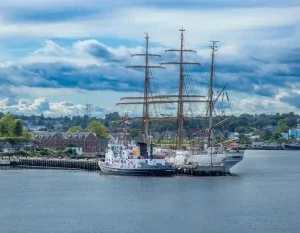 Scenic view of a tall ship docked at New London Harbor with dramatic skies overhead. in New London Connecticut Scavenger Hunt