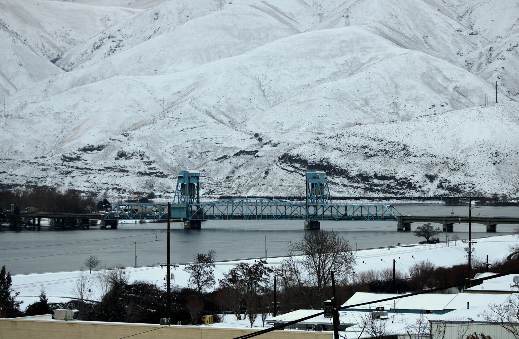 view of bridge on cloudy winter day with snow-covered mountains in background in Lewiston Idaho Scavenger Hunt