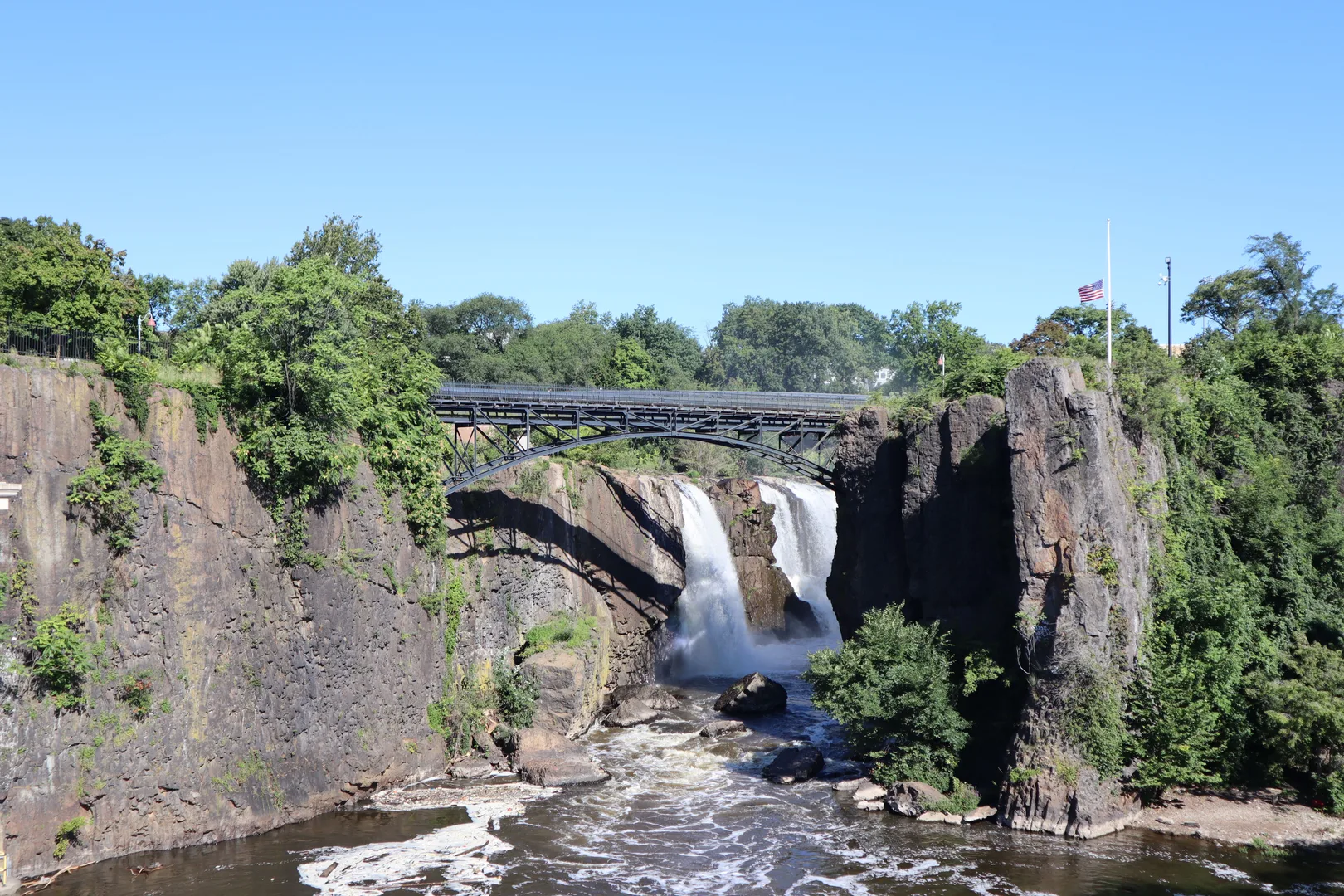 Beautiful view of Great Falls with cascading waterfall under blue skies in Paterson, New Jersey. in Paterson Scavenger Hunt, NJ