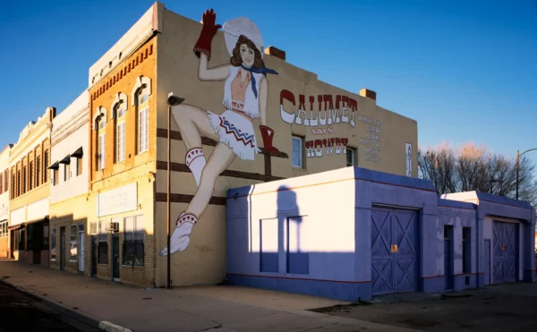 Downtown Las Vegas, New Mexico, has been the backdrop for several films, and one of them was an awful movie 'Red Dawn.' In that movie, the town was called Calumet, and during the night Russian Paratroopers invaded and tried to take over the community, but were warded off by the local kids from the high school. The mural in this shot was painted for the movie and decayed over the years. It got so bad that the town had an artist repaint it and it remains part of Las Vegas history. in Las Vegas New Mexico Scavenger Hunt, NM