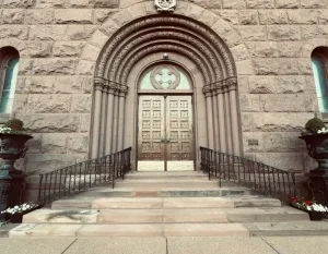 Ornate stone building entrance with arched doorway and intricate architectural details in Buffalo. in Buffalo New York Scavenger Hunt, NY