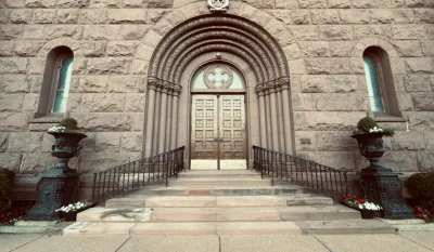 Ornate stone building entrance with arched doorway and intricate architectural details in Buffalo. in Buffalo New York Scavenger Hunt, NY