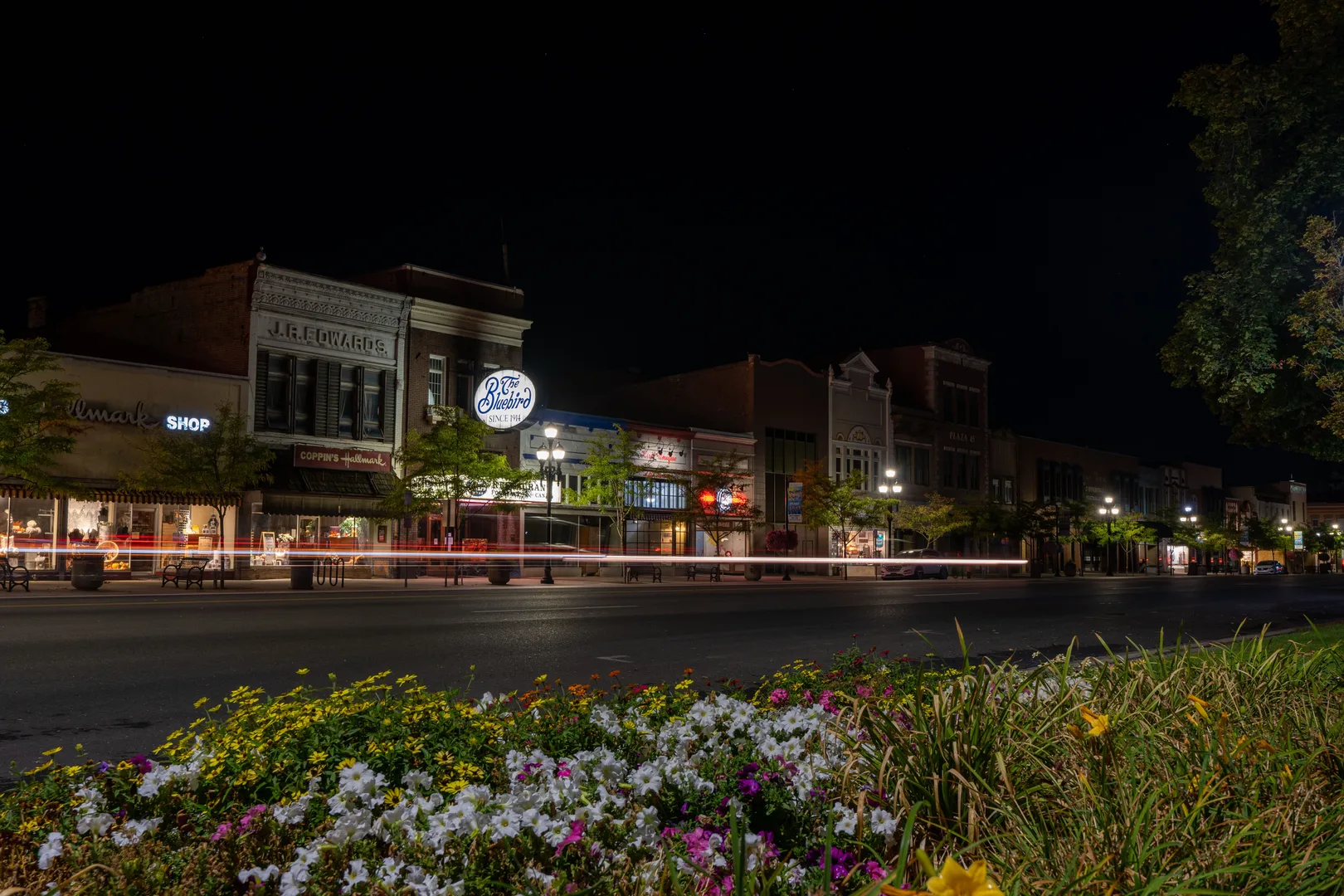 Captivating night scene of Logan, UT's historic downtown with light trails and blooming flowers. in Logan Scavenger Hunt, UT
