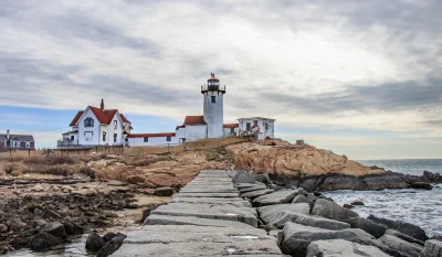 Captivating lighthouse on a rocky shore in Gloucester, Massachusetts. in Gloucester Massachusetts Scavenger Hunt