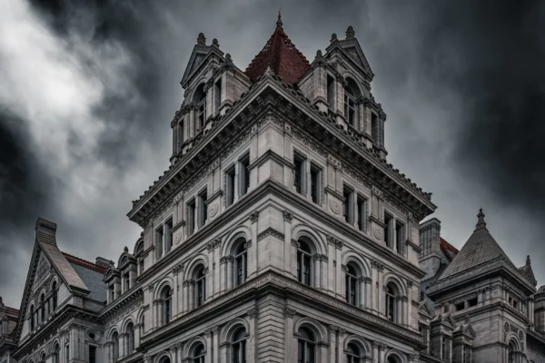 Dramatic view of the New York State Capitol building's Neo-Renaissance facade under stormy skies. in Albany New York Scavenger Hunt