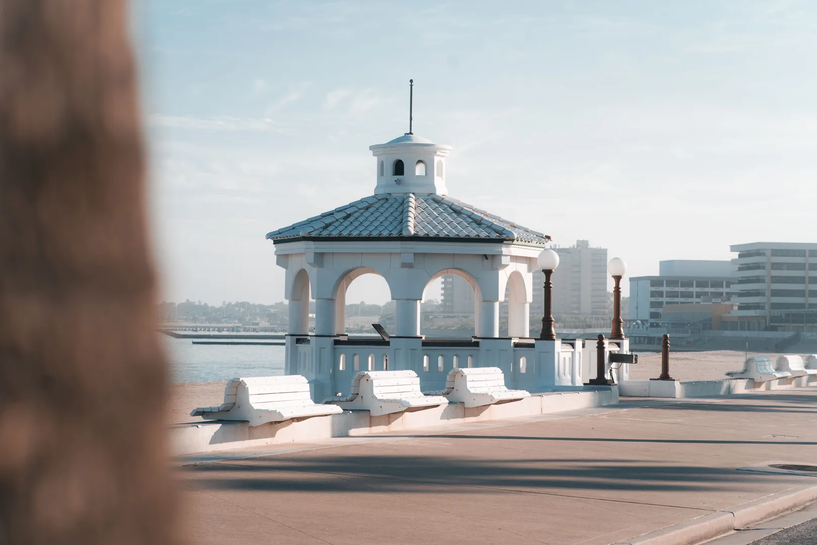 A scenic white gazebo overlooking the waterfront in Corpus Christi, Texas with a clear sky. in Corpus Christi Scavenger Hunt, TX