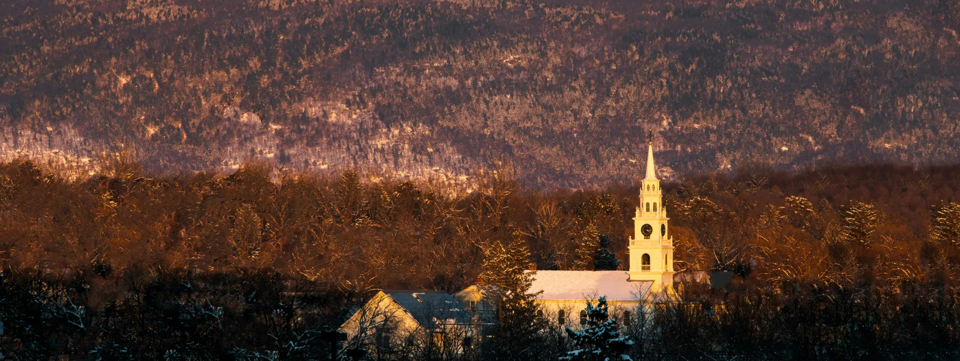 a church with a steeple surrounded by trees in Middlebury Scavenger Hunt, VT