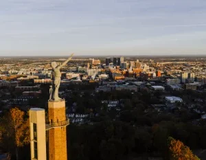 Drone capture of the Vulcan statue with Birmingham city skyline at sunset, Alabama. in Birmingham Alabama Scavenger Hunt