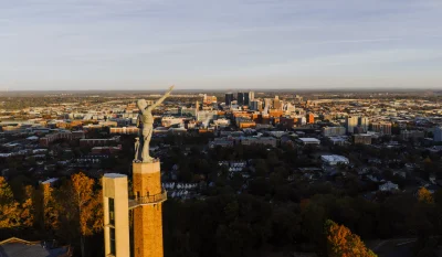 Drone capture of the Vulcan statue with Birmingham city skyline at sunset, Alabama. in Birmingham Alabama Scavenger Hunt