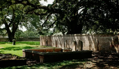 a stone wall with a bench in a park in Mobile Alabama Scavenger Hunt